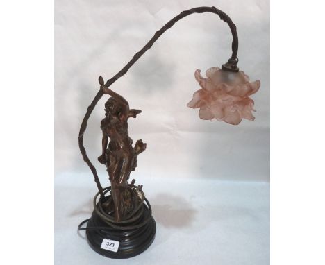 An early 20th century speltar figural table lamp. Glass petal shade damaged. 20' high