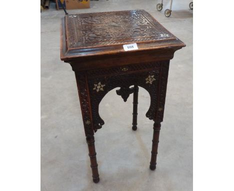 An Islamic carved hardwood occasional table with mother-of-pearl inlay