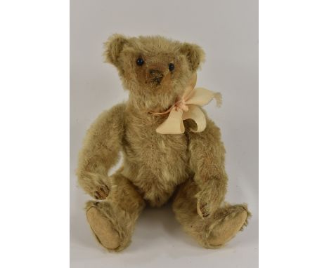 Steiff - an early 20th century bear, black ball button eyes, stitched nose, slight hump back, centre seamed golden body, felt