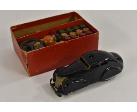 Schuco - a Telesteering 3000  clockwork tin plate car, blue black body, black base, steering wheel, key, twelve wooden cylind