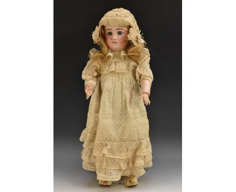 A bisque head doll, fixed pal blue eyes, closed mouth, long blond hair, composite body and limbs, white dress and bonnet, ind