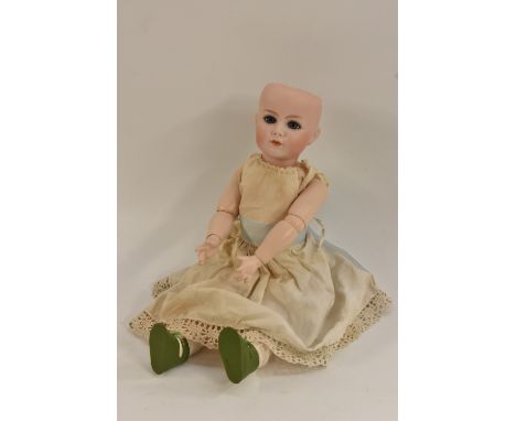 A Kammer & Reinhardt bisque head doll, with open blue eyes,  closed mouth,  incised K star R, Simon & Halbig, 117A, 55,  join