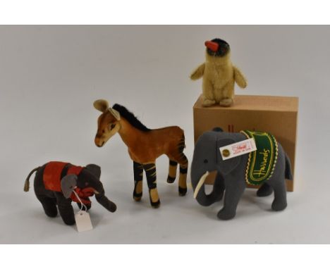 A modern Steiff Harrods felt elephant, white tag and ear button, boxed;  a Steiff Giraffe Calf standing, button no tag, 16cm 
