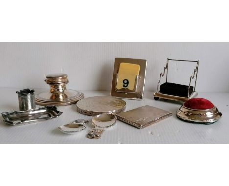 An assortment of Edwardian silver items to include a cigarette case, compact capstan (no insert), calendar, match holder, two