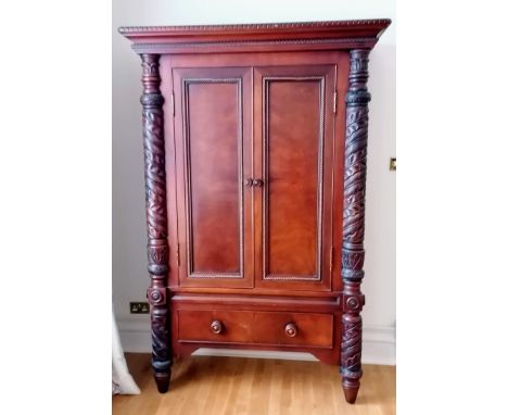 A Ralph Lauren Polo flame mahogany armoire with twin doors revealing a shelved interior, carved supports with drawer under, 2