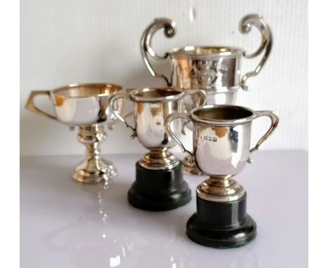 An Edwardian silver two-handled trophy cup on a stepped base by Mappin &amp; Webb, London, 1905, 14 h cm, inscribed 'Grove Sc