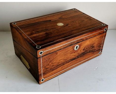 A 19th century rosewood writing slope with mother of pearl string inlay, recessed brass handles, secluded drawer, ink bottles