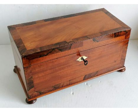 A Georgian mahogany and rosewood crossbanded tea caddy with ivory escutcheon, fitted interior with replacement bowl, on bun f