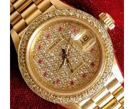 A Rolex ladies 18K gold diamond and ruby-set automatic wristwatch, with centre sweep seconds hand, date aperture, dial 20mm l