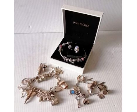 A Pandora charm bangle with original packaging and two other silver charm bracelets, 194g (3)