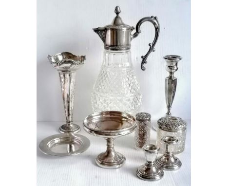 An assortment of late Victorian and Edwardian silver to include a pair of dwarf candlesticks, vase, single candlestick, tazza