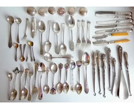 A miscellany of silver flatware to include souvenir spoons, forks, knives, button hooks, bottle tops, etc. Weighable silver 5