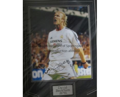 BECKHAM   Mounted signed photo (58cm x 44cm) of David Beckham playing in a Real Madrid match in season 2003/04. The signature