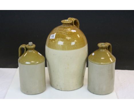 Three vintage Stoneware Jugs to include one marked for "Evens Bristol" and standing approx 37cm