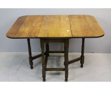 Oak Gate-leg Table raised on turned and square block supports, 120cms long x 91cms wide x 74cms high