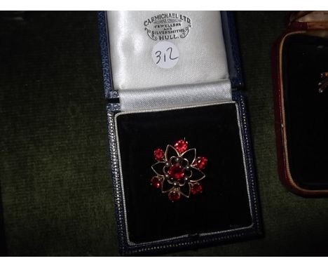 A 9ct gold seven stone Ruby garnet brooch