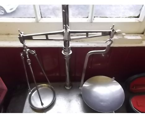 A set of white metal balance scales