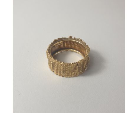 An Andrew Grima 18ct gold tree bark design wide band ring, weighing 8g, size Q. Shipping Group (A). 