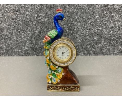 A miniature enamel clock with a perching peacock 11cm