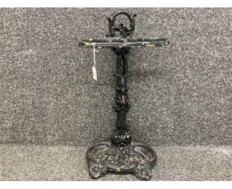 A cast iron stick stand painted in black