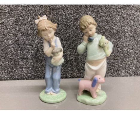 Nao by Lladro: Boy on phone with puppets no 1044 and girl with doll