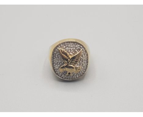 Gents 9ct yellow gold diamond set eagle ring comprising a cluster of brilliant round cut diamomds with a gold eagle on the to