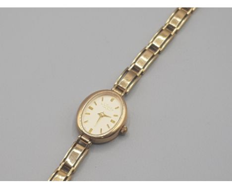 Ladies 9ct yellow gold rotary wrist watch featuring a oval case with champagne dial quartz movement with 9ct yellow gold brac