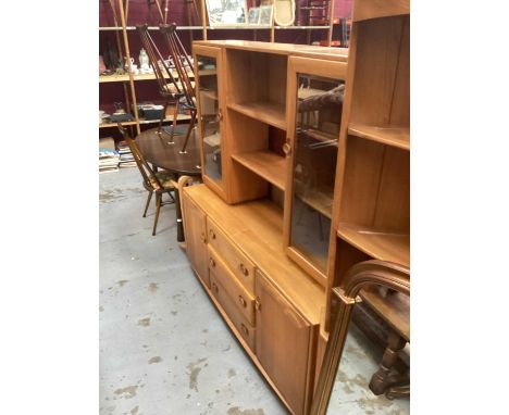 Ercol Windsor two height display cabinet with open central shelves above flanked by two glazed doors, three central drawers b