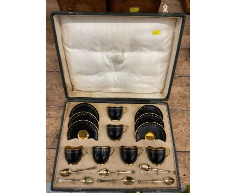 Royal Worcester six person coffee set in case, decorated in black and gold, with gilt patterns to borders, with six silver gi