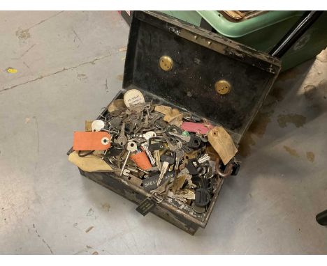 Tin containing a quantity of assorted vintage car keys and other keys.