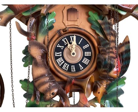 Vintage Black Forest Cuckoo clock with Stag &amp; crossed hunting rifle, game and horn decoration, Roman numeral dial and con