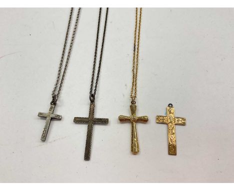Two 9ct gold cross pendants, one on a yellow metal chain and two silver cross pendants on chainsTwo 9ct gold crosses and one 
