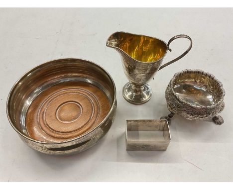 Silver wine coaster, Victorian silver cream jug, silver cauldron salt and a silver rectangular napkin ring (4)Wine coaster- (