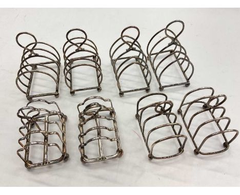 Four pairs of silver toast racks, various dates and makers Total weight 334 grams
