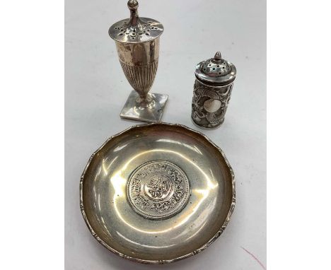 Two late 19th/early 20th century Chinese silver pepper pots, together with a Hong Kong silver dish. (3)Total weight 146 grams