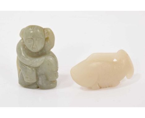Two Chinese cared jade figures, including carving in the form of a carp, 8cm long, the other carved as a figure riding a myth