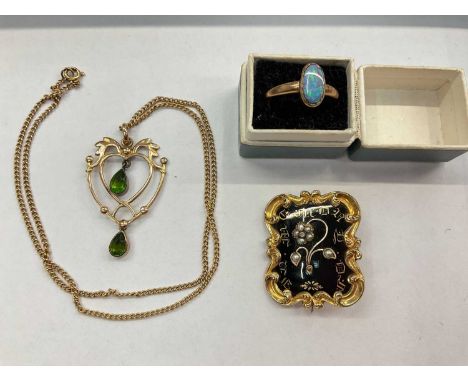 Victorian yellow metal and black enamel mourning brooch, Edwardian 9ct gold open work peridot pendant on 9ct gold chain and 9