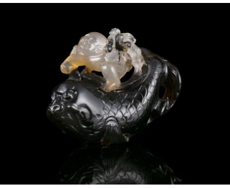 PROPERTIES FROM A FRENCH COLLECTOR OF JADE CARVINGS AND SNUFFBOTTLES  A POSSIBLY SUZHOU AGATE GROUP CARVING OF A BOY RIDING A