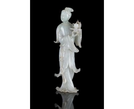 A FINE JADEITE JADE CARVING OF A STANDING MEIREN CHINA, CIRCA 1900-1930 The stone of white tone with apple green infusions an