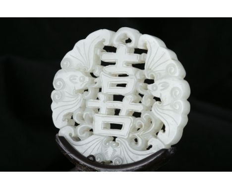A RETICULATED JADE ‘HAPPINESS - XǏ - 喜’ PENDANT / PLAQUE CHINA, QING DYNASTY Of circular shape, open-worked with three bats a
