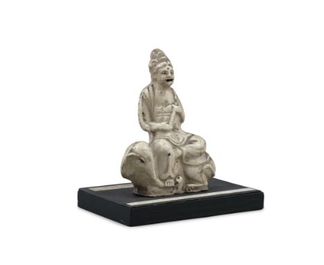 A BEIGE-GLAZED CERAMIC MODEL OF A GUANYIN SEATED ON AN ELEPHANT CHINA, QING DYNASTY Modeled as a figure of Guanyin or Bodhisa