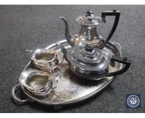 A silver plated twin-handled gallery tray on paw feet and a four-piece Sheffield plate tea service 