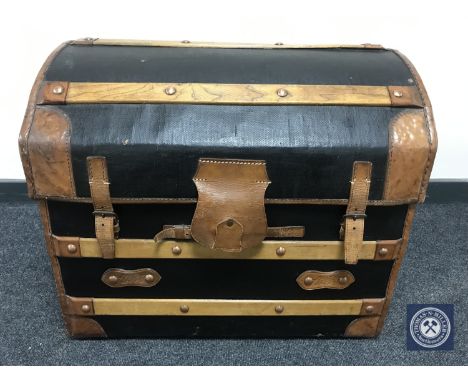 An early 20th century oak and leather bound domed topped trunk 