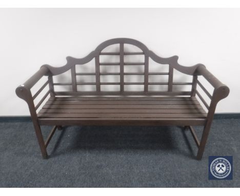 A teak scroll arm bench
