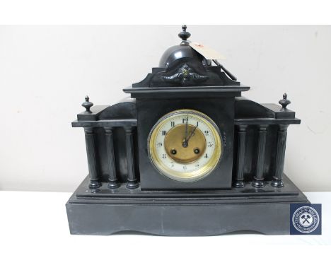 A Victorian slate mantel clock with brass and enamel dial 