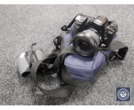 A Minolta Dynax 500 SI camera with lens in carry bag, together with a pair of binoculars