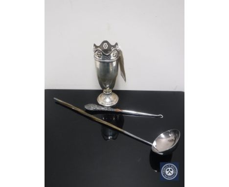 A silver pierced rimmed vase, 13.5 cm, with weighted base, a silver handled button hook and a ladle 