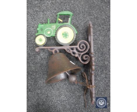 A cast metal tractor wall bracket with bell 