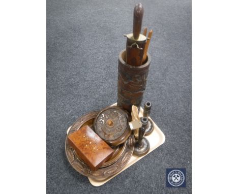 A tray of assorted wooden pieces including carved hardwood stick pot, two carved oak bowls, lidded pot, candlesticks etc