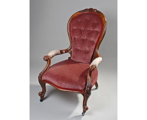 Victorian button armchair, the arched back with stuff over seat, curved arms and cabriole legs